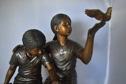Two Kids on Rocks with a Bird Bronze Statue -  Size: 36"L x 30"W x 44"H. 