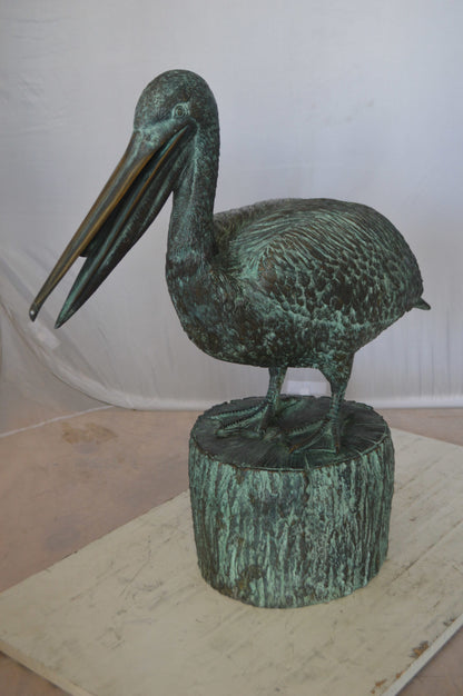 Pelican on a Tree Stump fountain bronze statue -  Size: 30"L x 16"W x 46"H. 