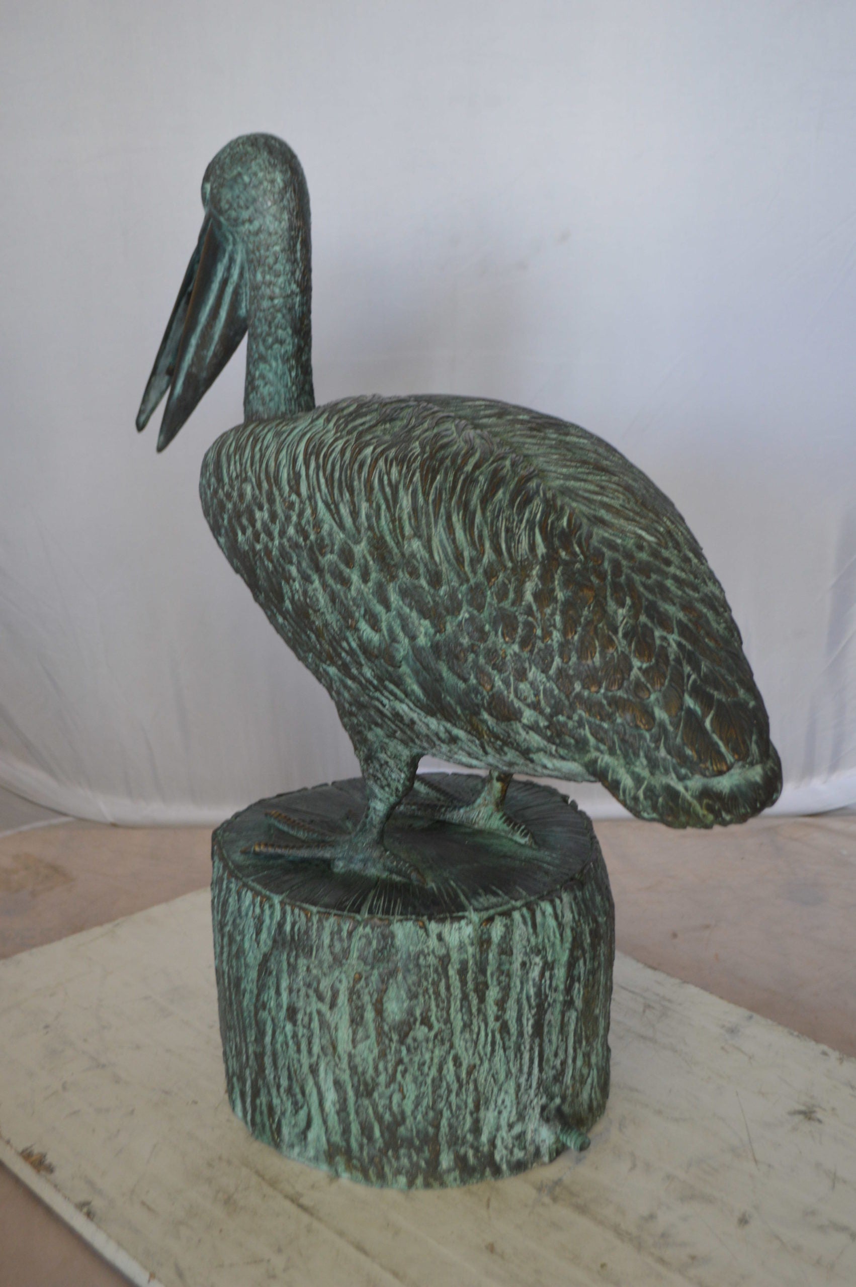 Pelican on a Tree Stump fountain bronze statue -  Size: 30"L x 16"W x 46"H. 