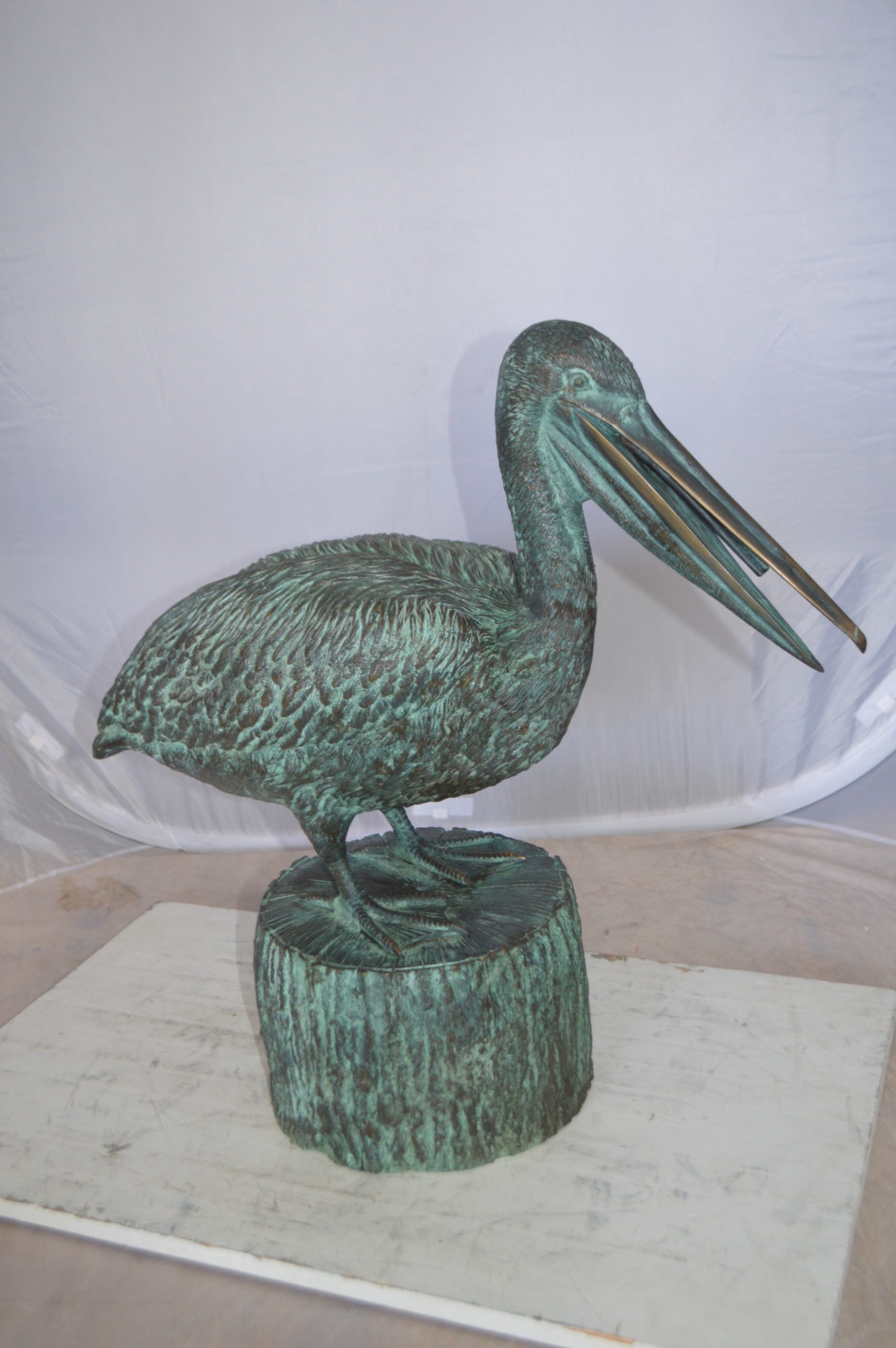 Pelican on a Tree Stump fountain bronze statue -  Size: 30"L x 16"W x 46"H. 