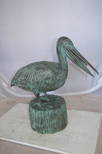 Pelican on a Tree Stump fountain bronze statue -  Size: 30"L x 16"W x 46"H. 