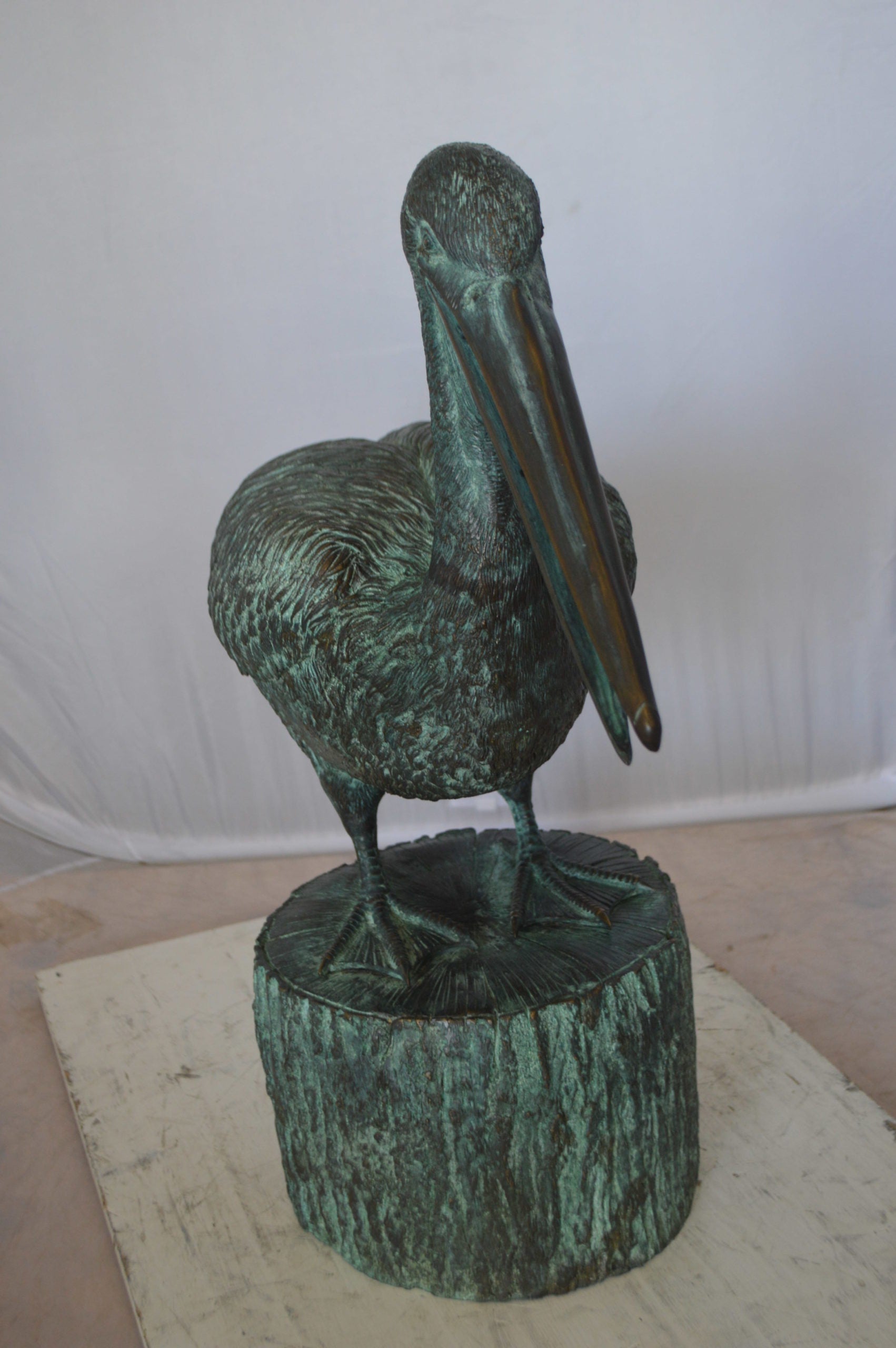 Pelican on a Tree Stump fountain bronze statue -  Size: 30"L x 16"W x 46"H. 