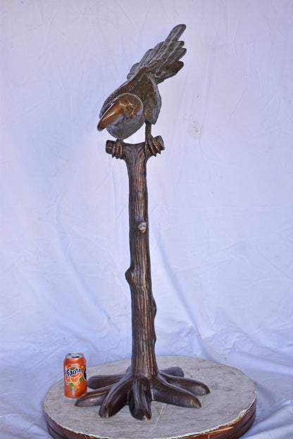 Parrot on a Tree looking Down Bronze Statue - Size: 37"L x 15"W x 47"H.