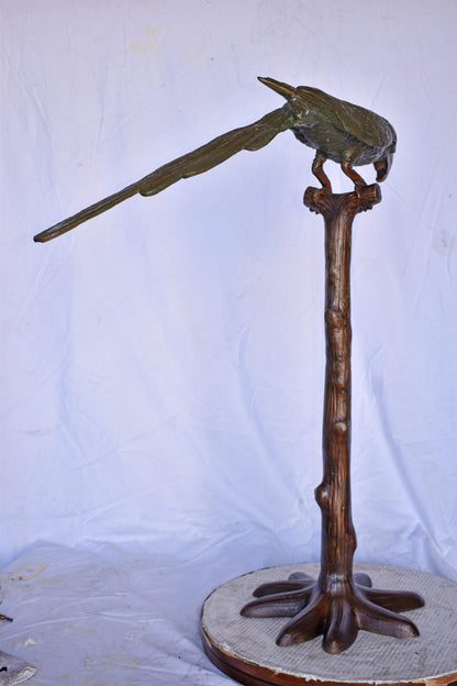 Parrot on a Tree Watching Forward Bronze Statue - Size: 36"L x 15"W x 41"H.