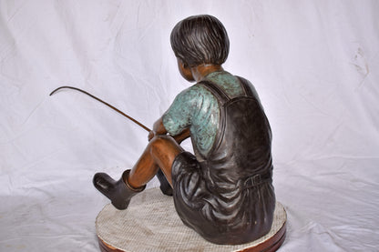 Boy Sitting on the Ground, Fishing Bronze Statue - Size: 26"L x 15"W x 25"H.