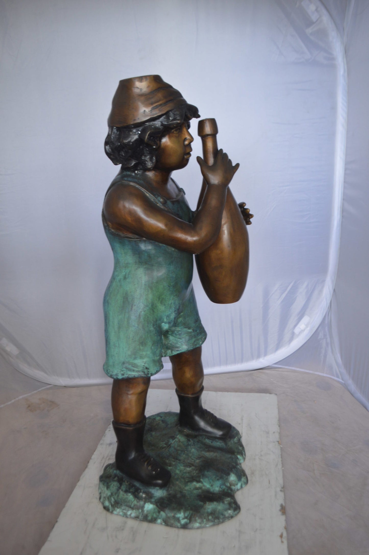 Boy holding a bottle water fountain -  Size: 17"L x 14"W x 38"H. 