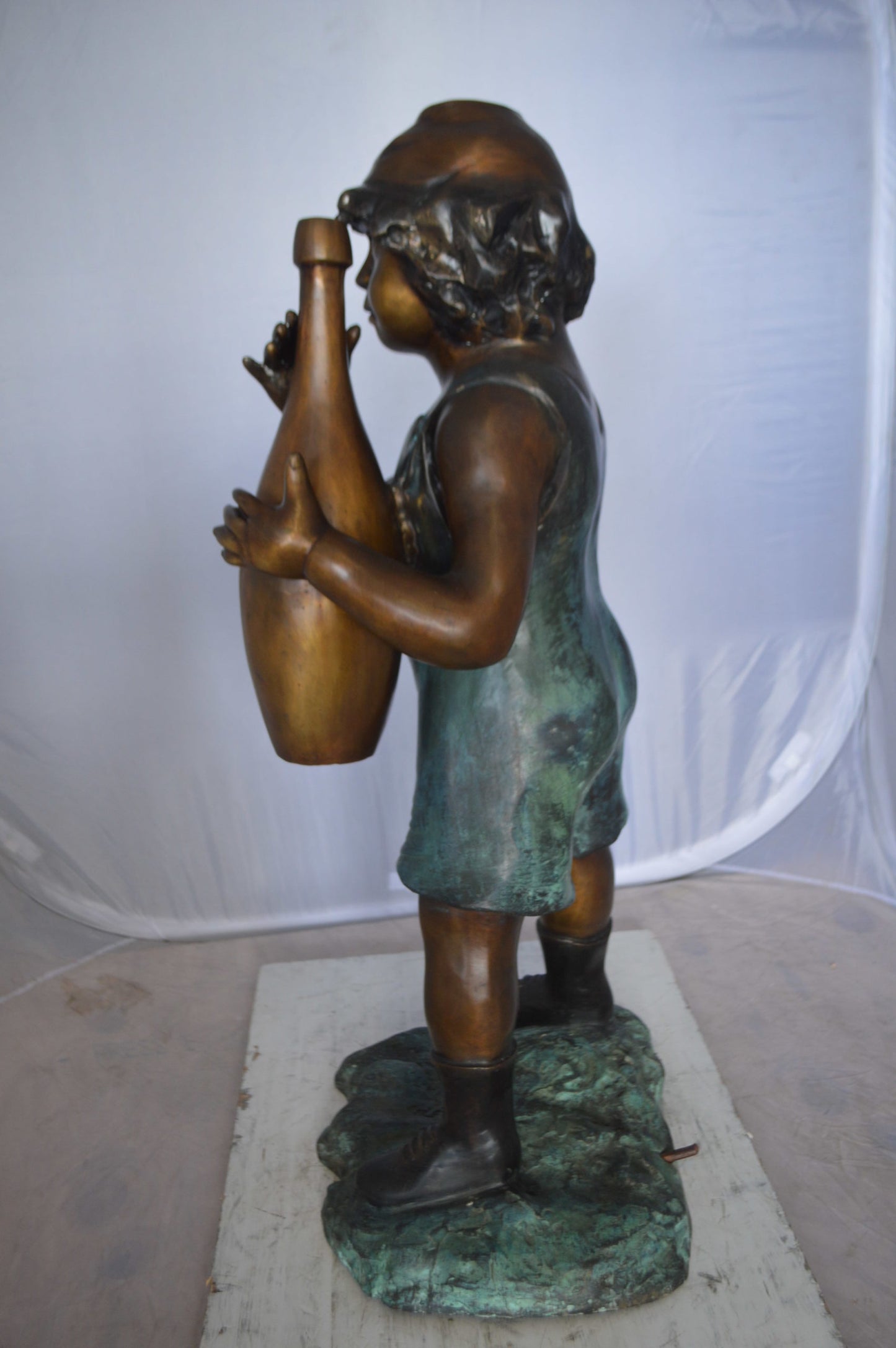 Boy holding a bottle water fountain -  Size: 17"L x 14"W x 38"H. 