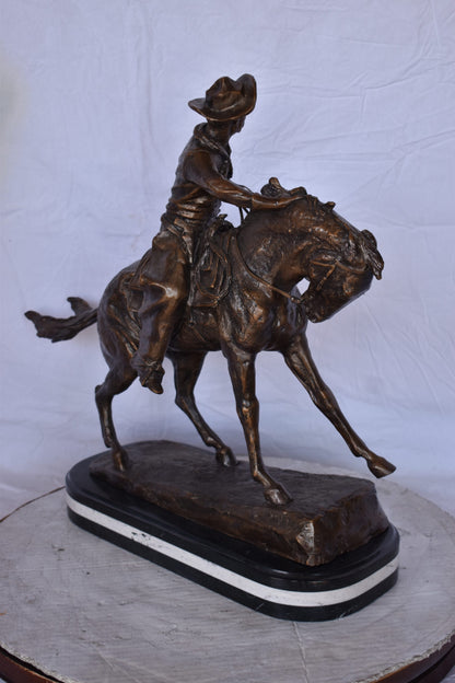 Remington Cowboy Replica Bronze Statue on Triple Marble - Size: 8"x 26"x 23"H.