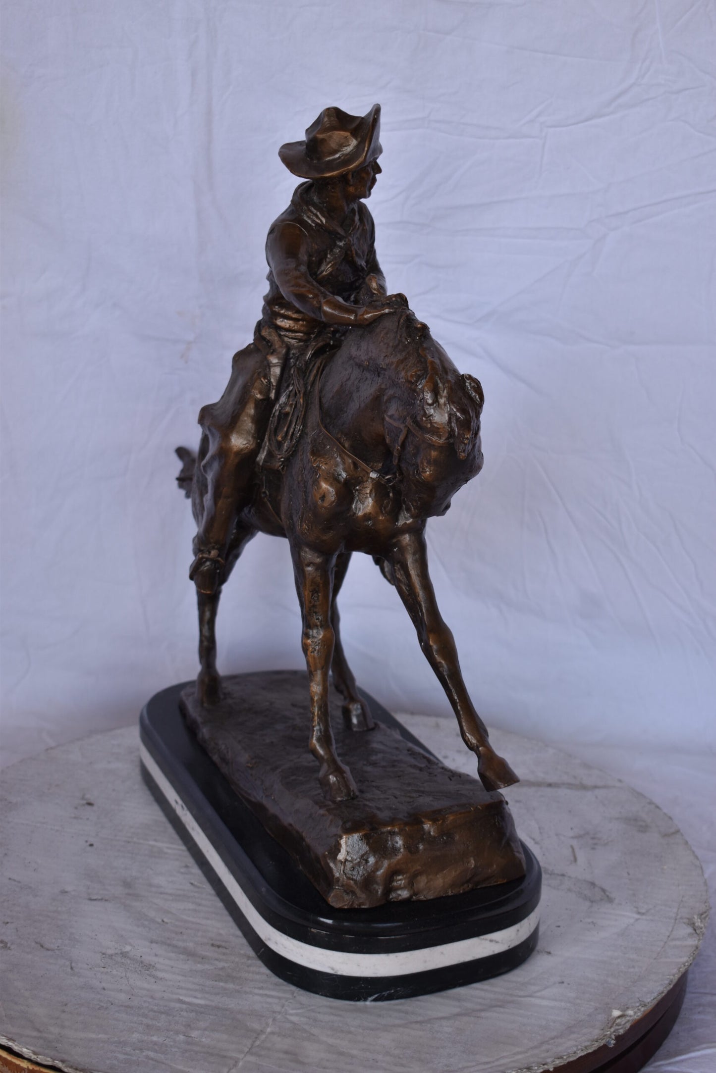 Remington Cowboy Replica Bronze Statue on Triple Marble - Size: 8"x 26"x 23"H.