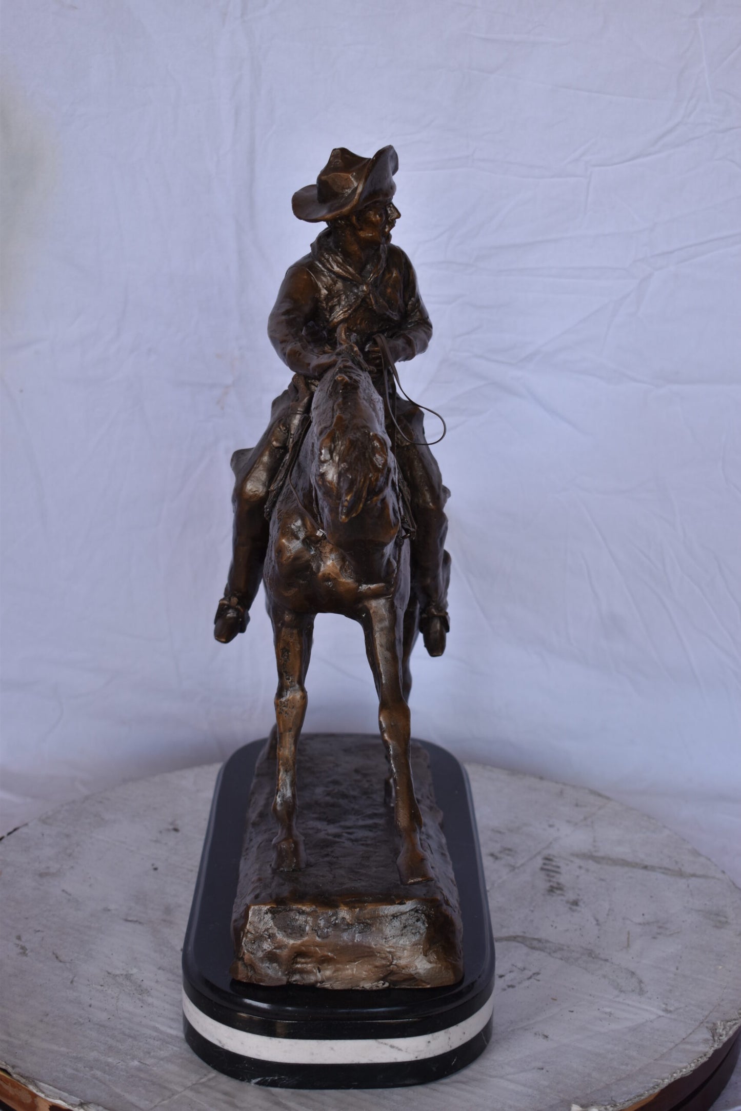 Remington Cowboy Replica Bronze Statue on Triple Marble - Size: 8"x 26"x 23"H.