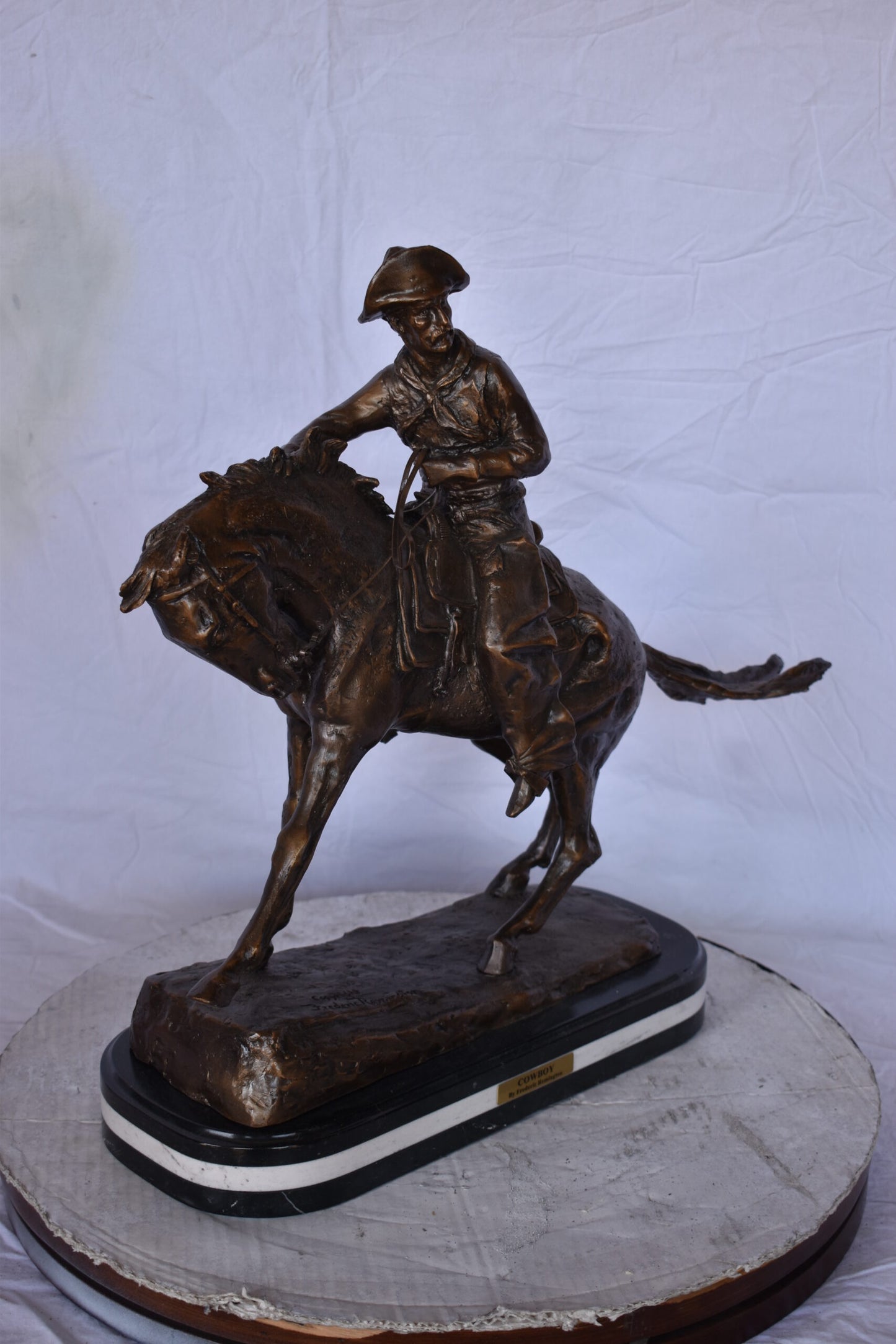 Remington Cowboy Replica Bronze Statue on Triple Marble - Size: 8"x 26"x 23"H.
