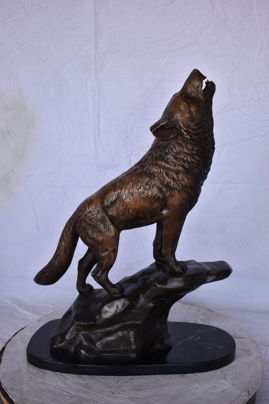 Howling Wolf at Edge of a Cliff Bronze Statue - Size: 9"L x 20"W x 26"H.