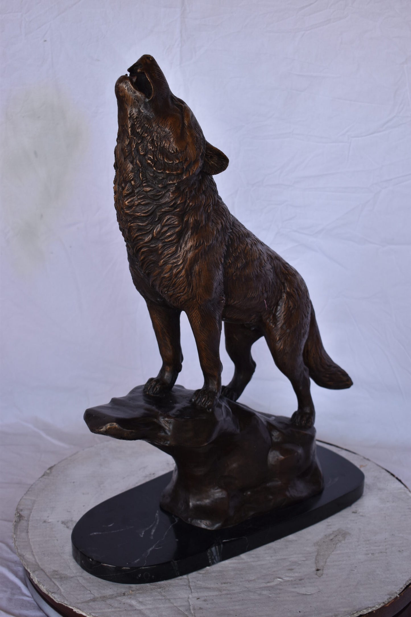 Howling Wolf at Edge of a Cliff Bronze Statue - Size: 9"L x 20"W x 26"H.