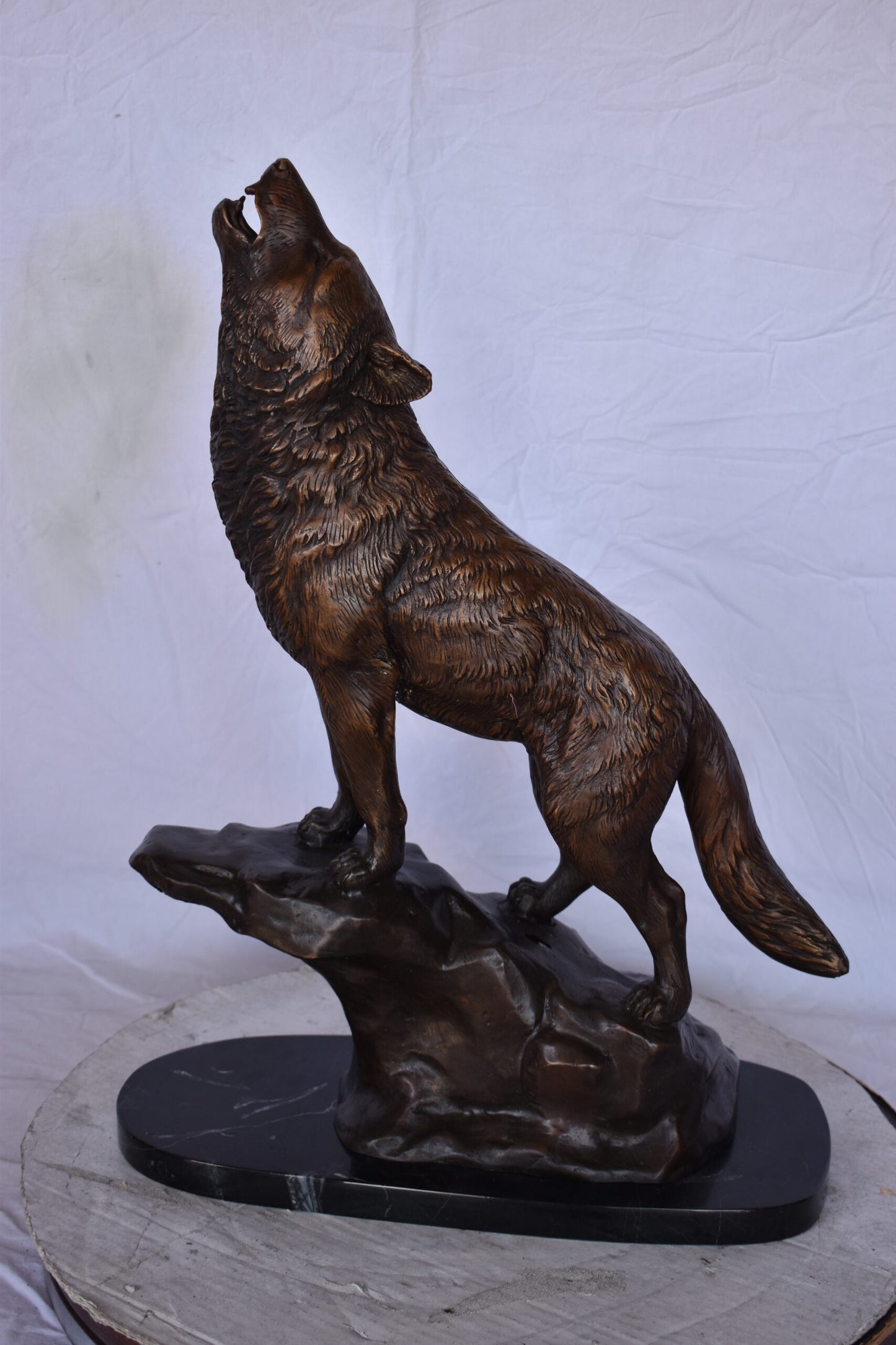 Howling Wolf at Edge of a Cliff Bronze Statue - Size: 9"L x 20"W x 26"H.