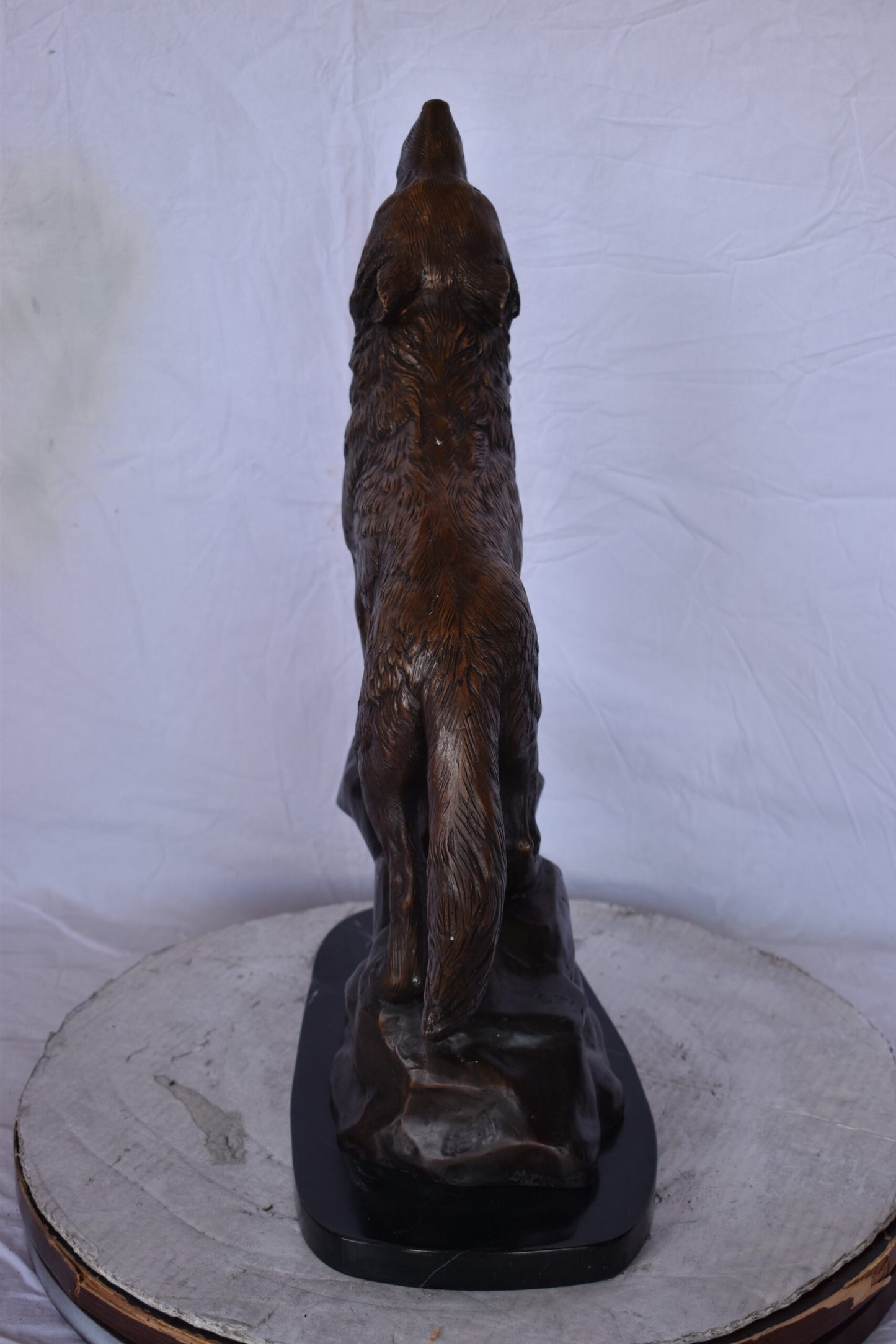 Howling Wolf at Edge of a Cliff Bronze Statue - Size: 9"L x 20"W x 26"H.