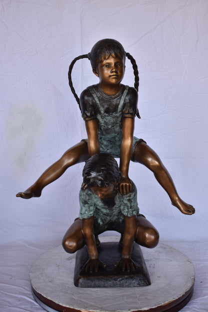 Boy and Girl Leapfrog Jumping Bronze Statue - Size: 25"L x 20"W x 32"H.