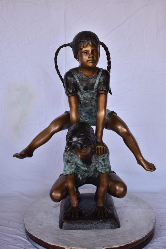 Boy and Girl Leapfrog Jumping Bronze Statue - Size: 25"L x 20"W x 32"H.