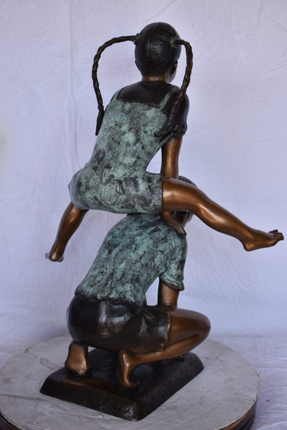 Boy and Girl Leapfrog Jumping Bronze Statue - Size: 25"L x 20"W x 32"H.