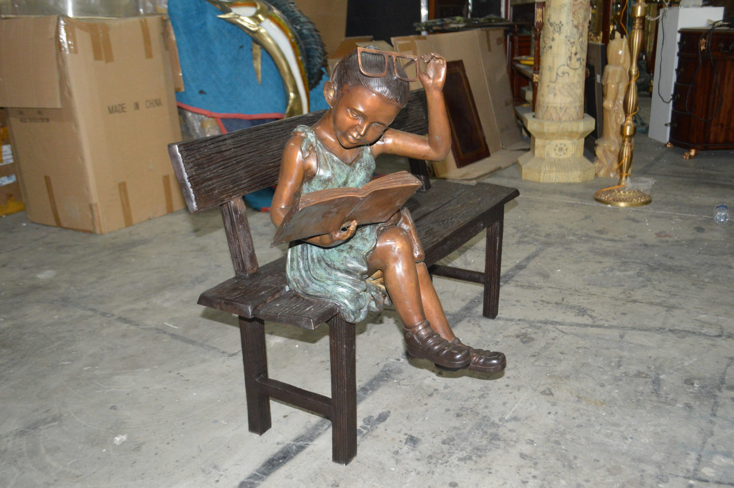 Girl with Glasses on Bench  Bronze Statue -  Size: 43"L x 20"W x 36"H.