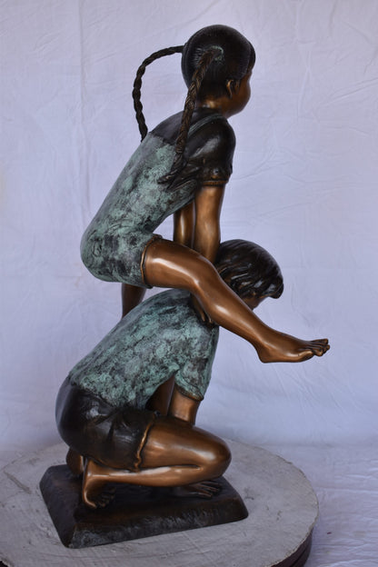 Boy and Girl Leapfrog Jumping Bronze Statue - Size: 25"L x 20"W x 32"H.