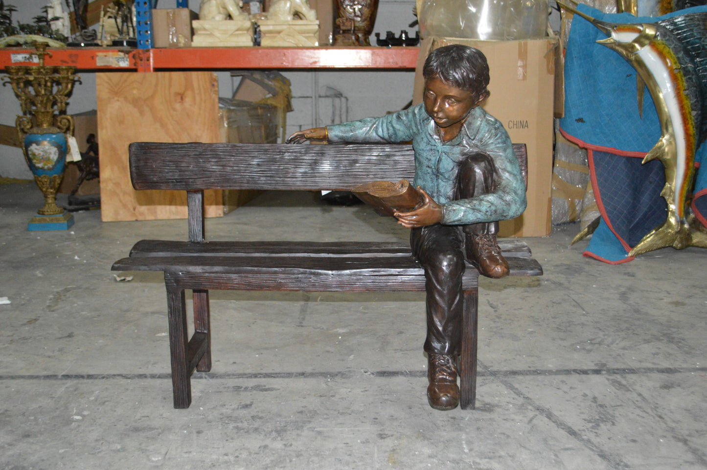 boy Sitting on a Bench reading book bronze Statue -  Size: 43"L x 20"W x 36"H.