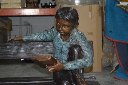 boy Sitting on a Bench reading book bronze Statue -  Size: 43"L x 20"W x 36"H.