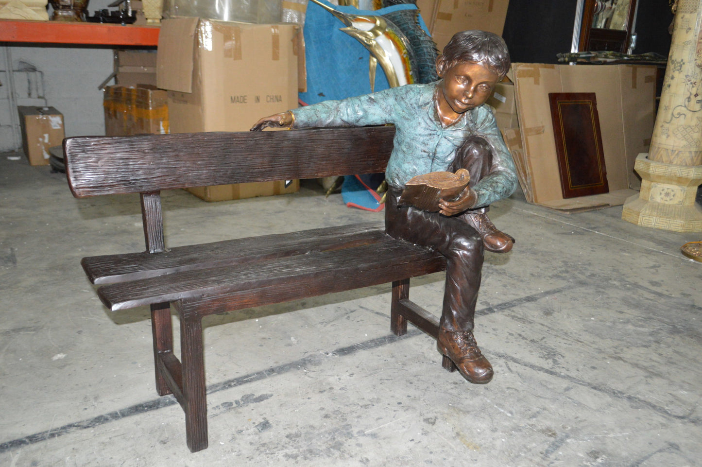 boy Sitting on a Bench reading book bronze Statue -  Size: 43"L x 20"W x 36"H.