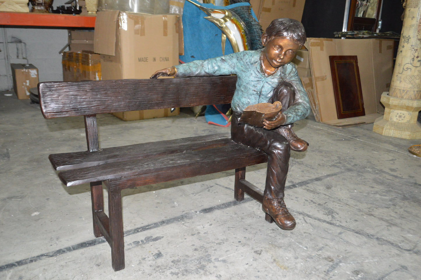 boy Sitting on a Bench reading book bronze Statue -  Size: 43"L x 20"W x 36"H.