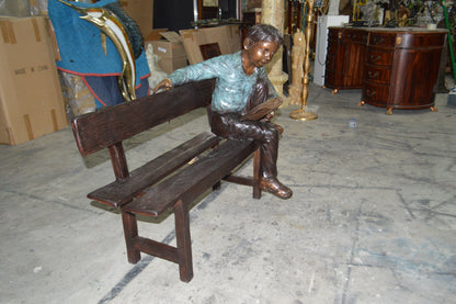 boy Sitting on a Bench reading book bronze Statue -  Size: 43"L x 20"W x 36"H.