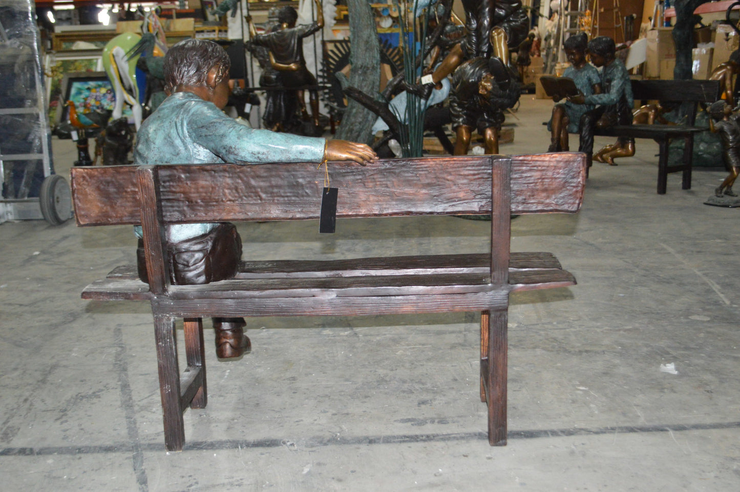 boy Sitting on a Bench reading book bronze Statue -  Size: 43"L x 20"W x 36"H.