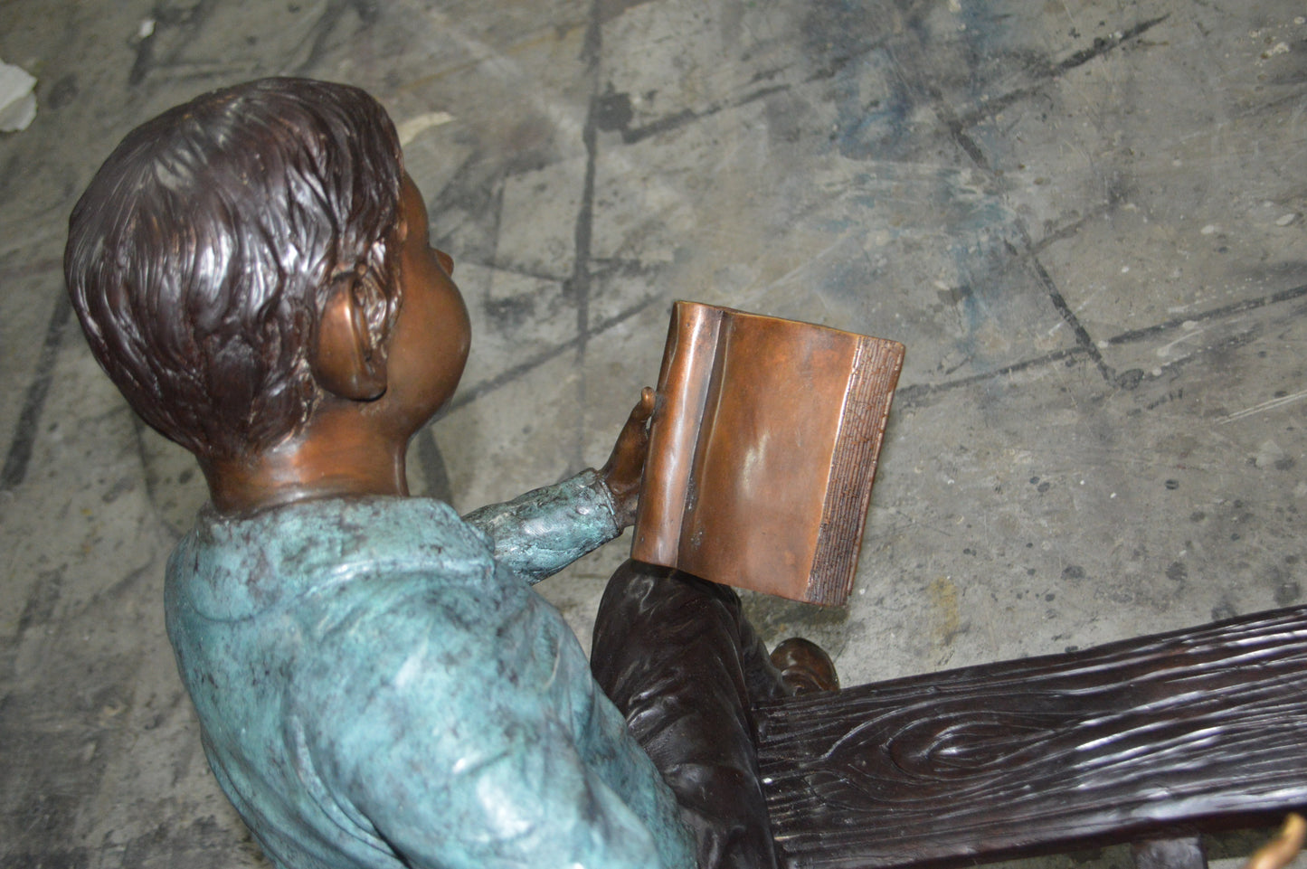 boy Sitting on a Bench reading book bronze Statue -  Size: 43"L x 20"W x 36"H.