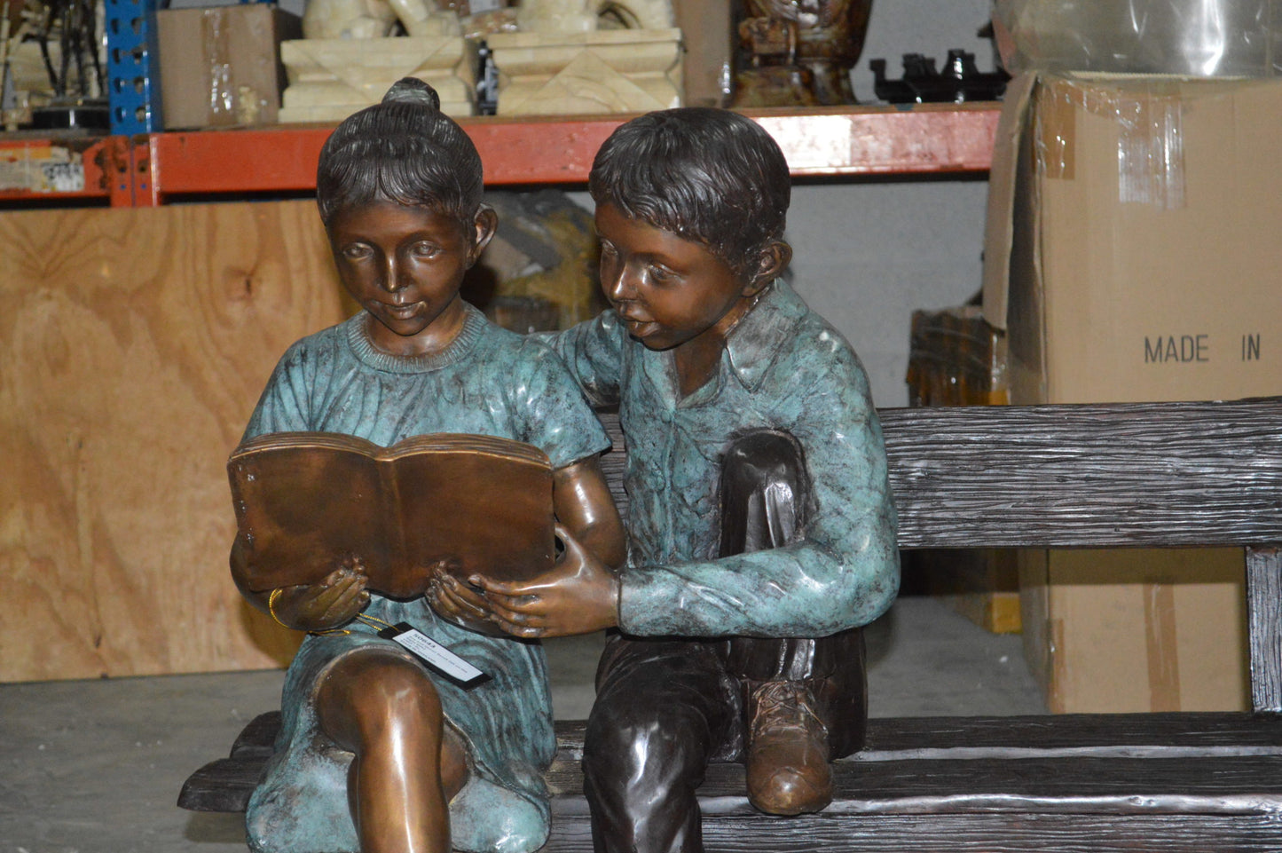 Boy and a Girl on Bench reading book bronze Statue -  Size: 43"L x 20"W x 36"H.