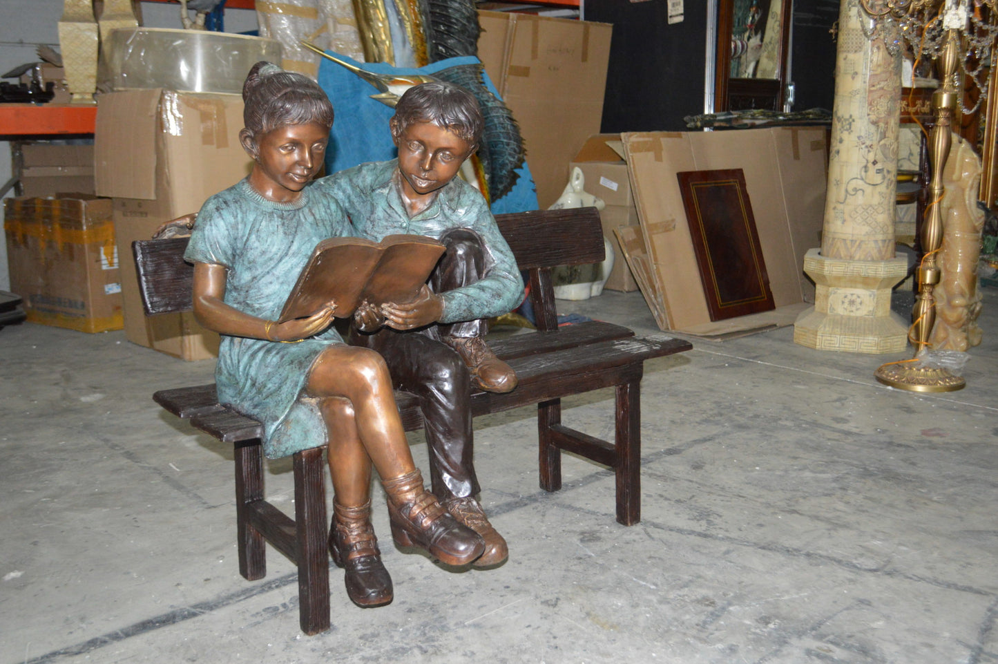 Boy and a Girl on Bench reading book bronze Statue -  Size: 43"L x 20"W x 36"H.