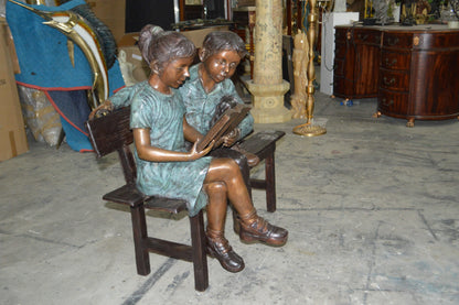 Boy and a Girl on Bench reading book bronze Statue -  Size: 43"L x 20"W x 36"H.