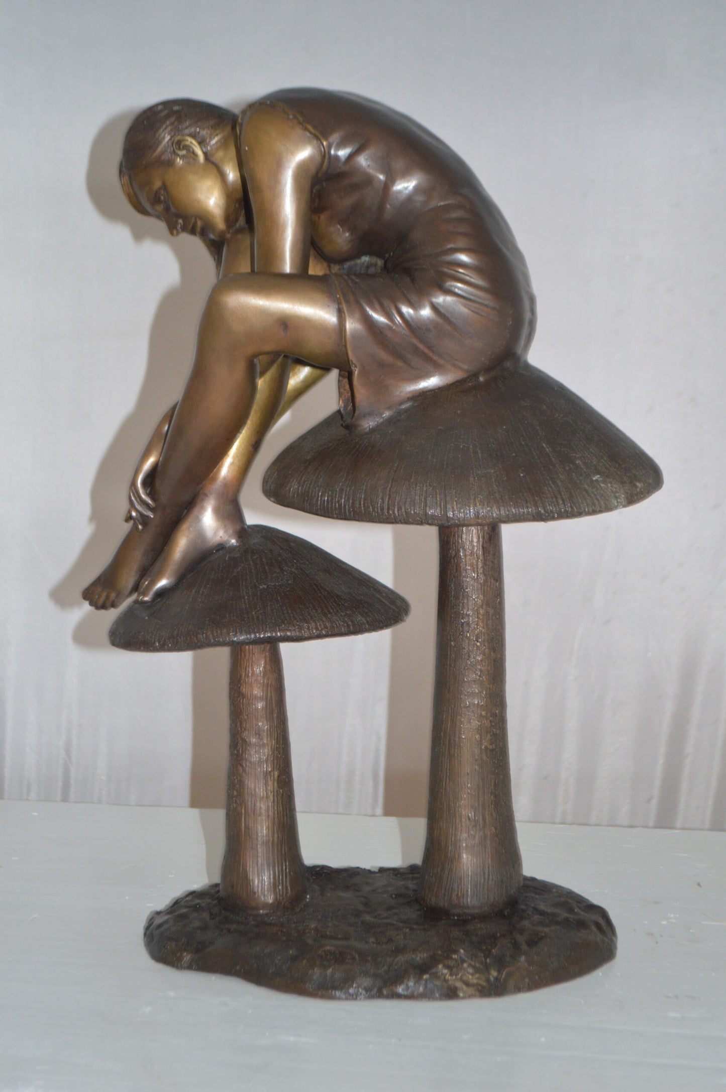 Girl sitting on Mushrooms Bronze Statue -  Size: 13"L x 11"W x 18"H.