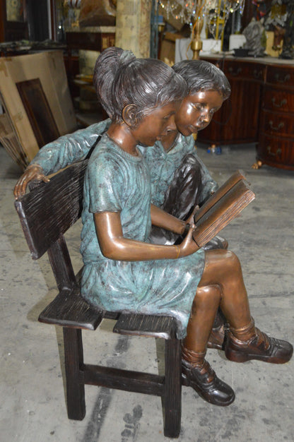 Boy and a Girl on Bench reading book bronze Statue -  Size: 43"L x 20"W x 36"H.