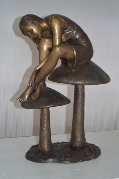 Girl sitting on Mushrooms Bronze Statue -  Size: 13"L x 11"W x 18"H.