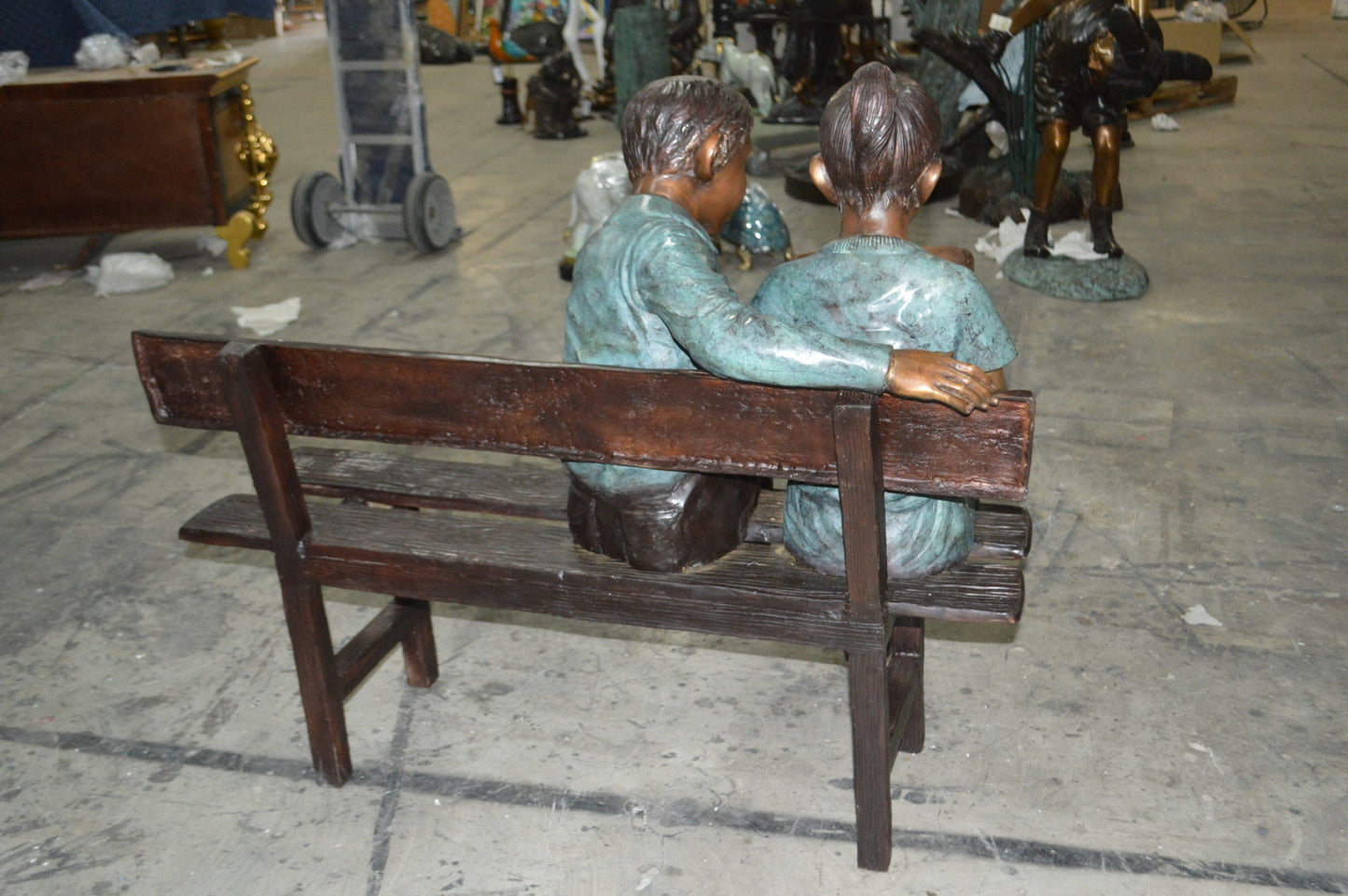 Boy and a Girl on Bench reading book bronze Statue -  Size: 43"L x 20"W x 36"H.