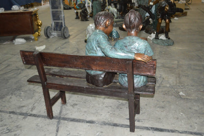 Boy and a Girl on Bench reading book bronze Statue -  Size: 43"L x 20"W x 36"H.