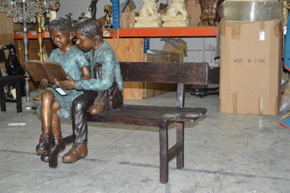 Boy and a Girl on Bench reading book bronze Statue -  Size: 43"L x 20"W x 36"H.