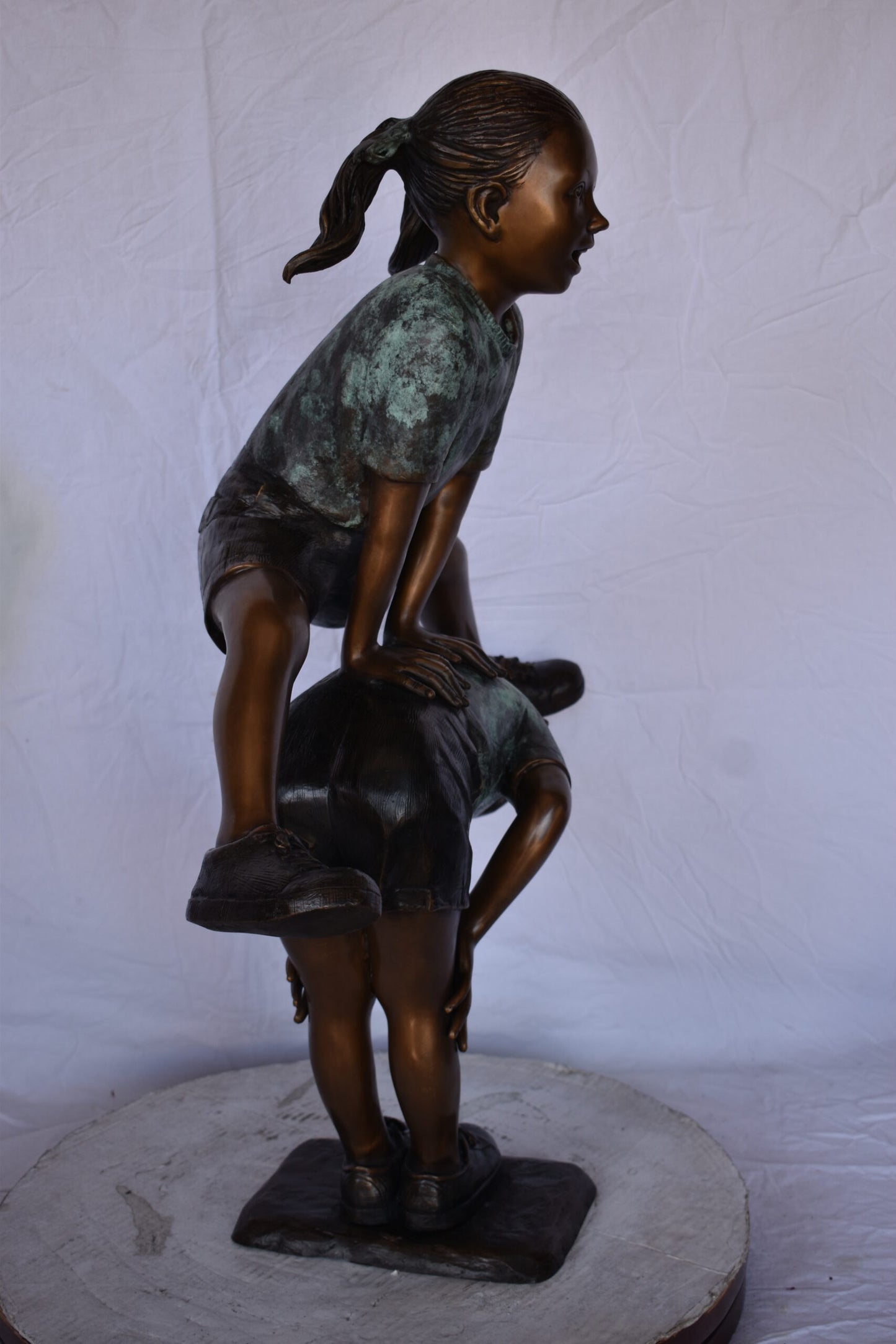 Two Girls Playing Leapfrog Jumping Bronze Statue - Size: 30"L x 14"W x 34"H.