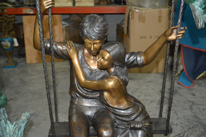 Lovers on a Swing Bronze Statue -  Size: 48"L x 32"W x 64"H.
