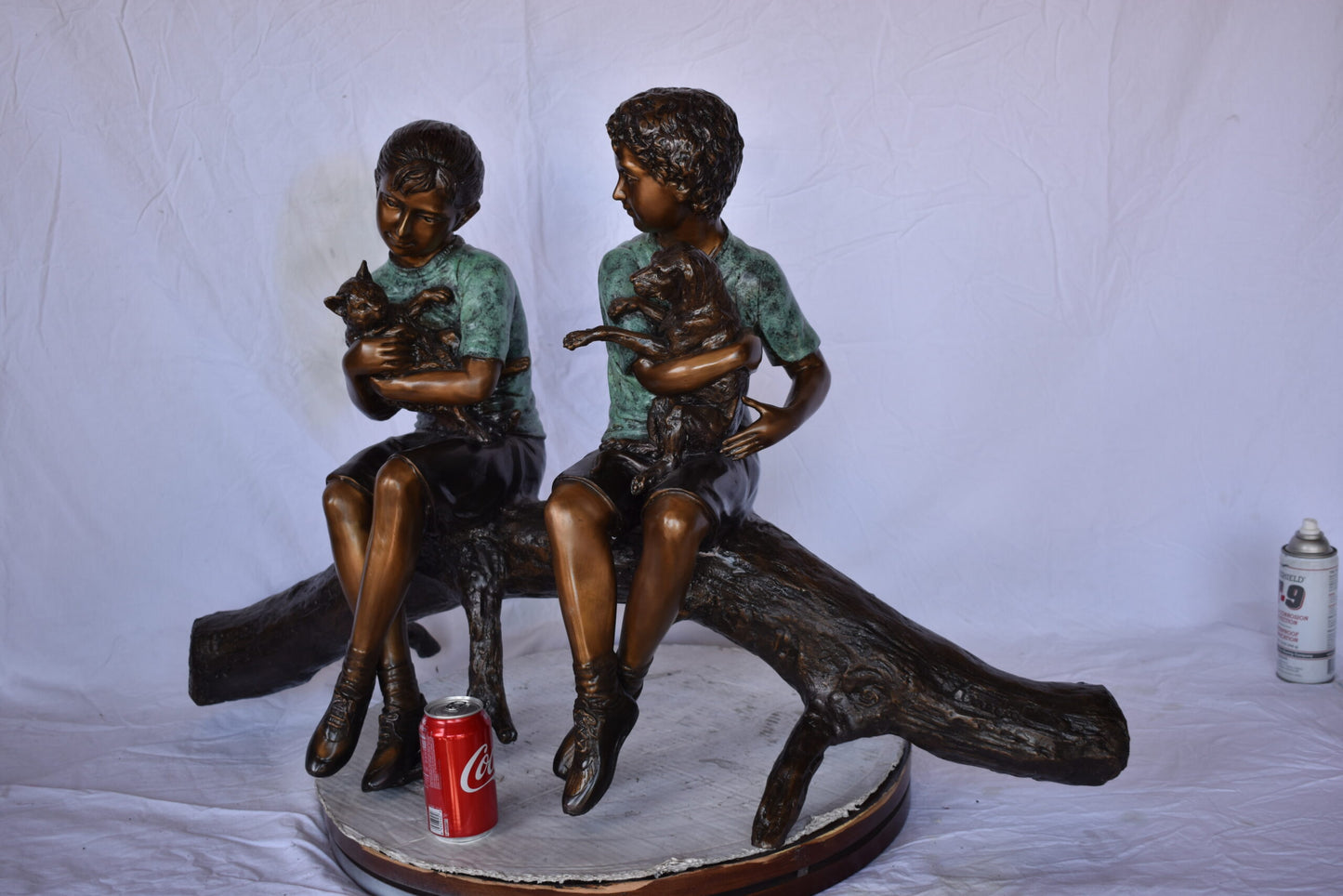 Boy and Girl with Pets Sitting on Log Bronze Statue - Size: 44"L x 22"W x 26"H.