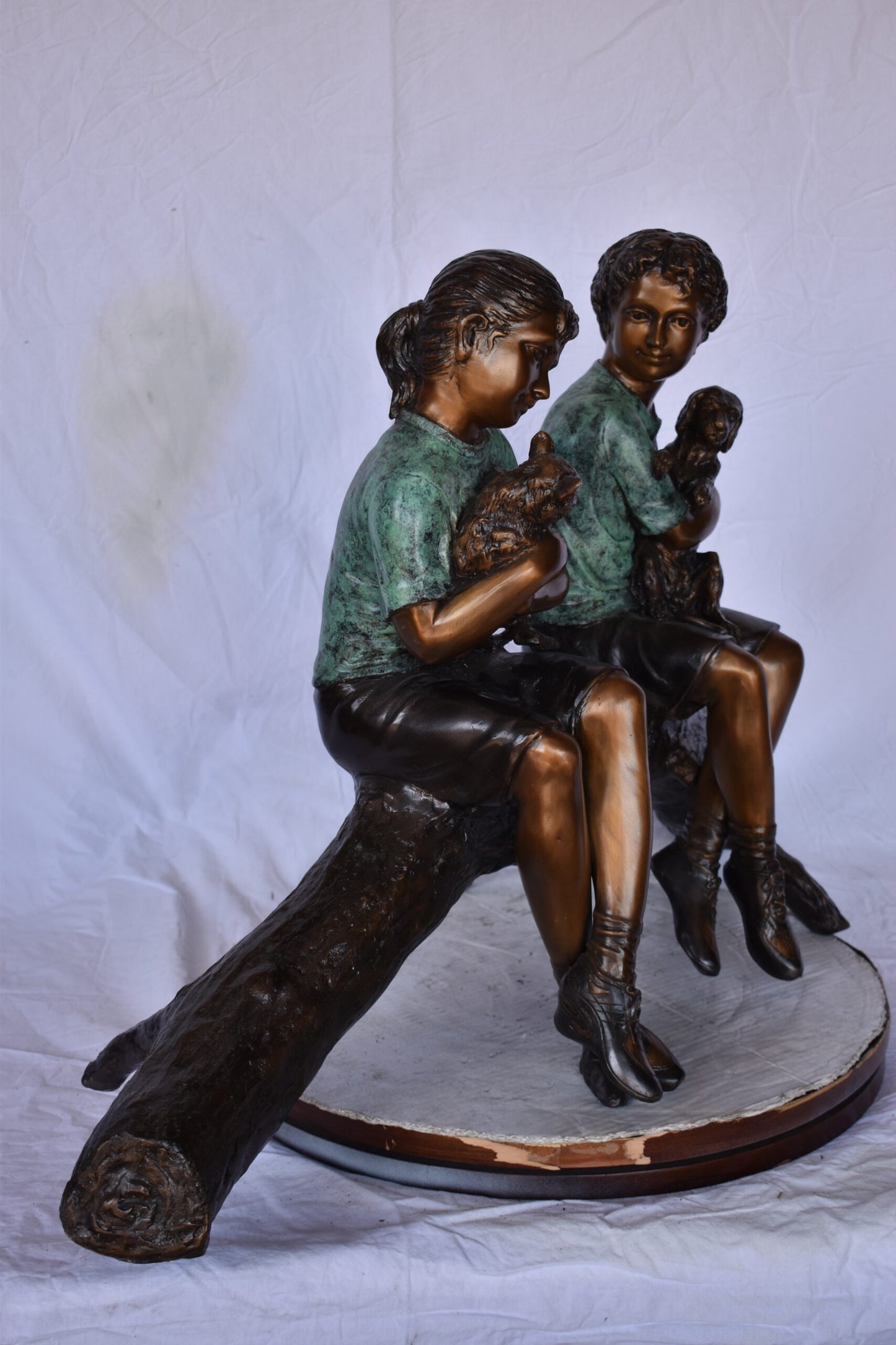 Boy and Girl with Pets Sitting on Log Bronze Statue - Size: 44"L x 22"W x 26"H.