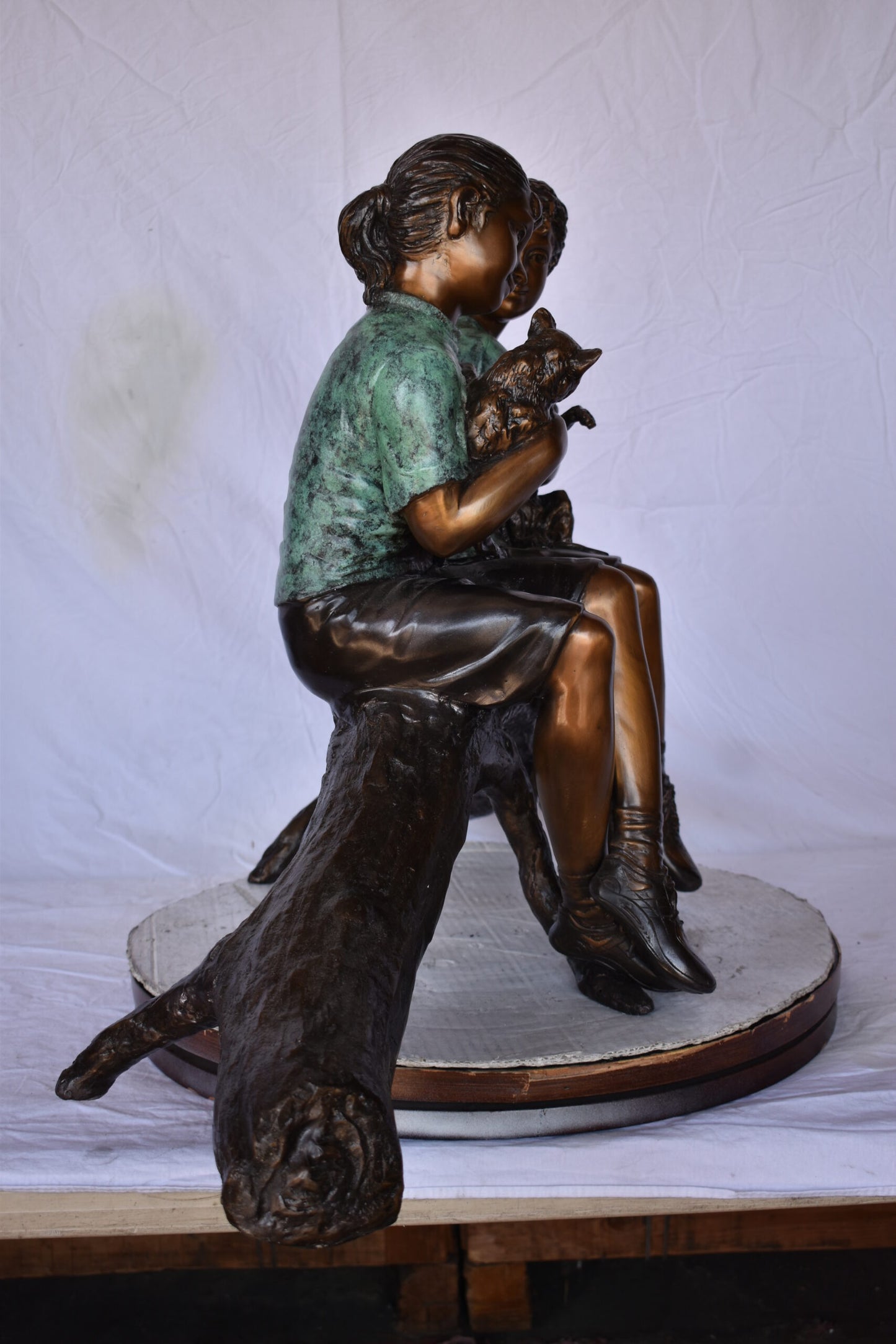 Boy and Girl with Pets Sitting on Log Bronze Statue - Size: 44"L x 22"W x 26"H.