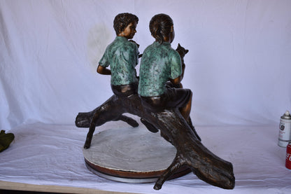 Boy and Girl with Pets Sitting on Log Bronze Statue - Size: 44"L x 22"W x 26"H.
