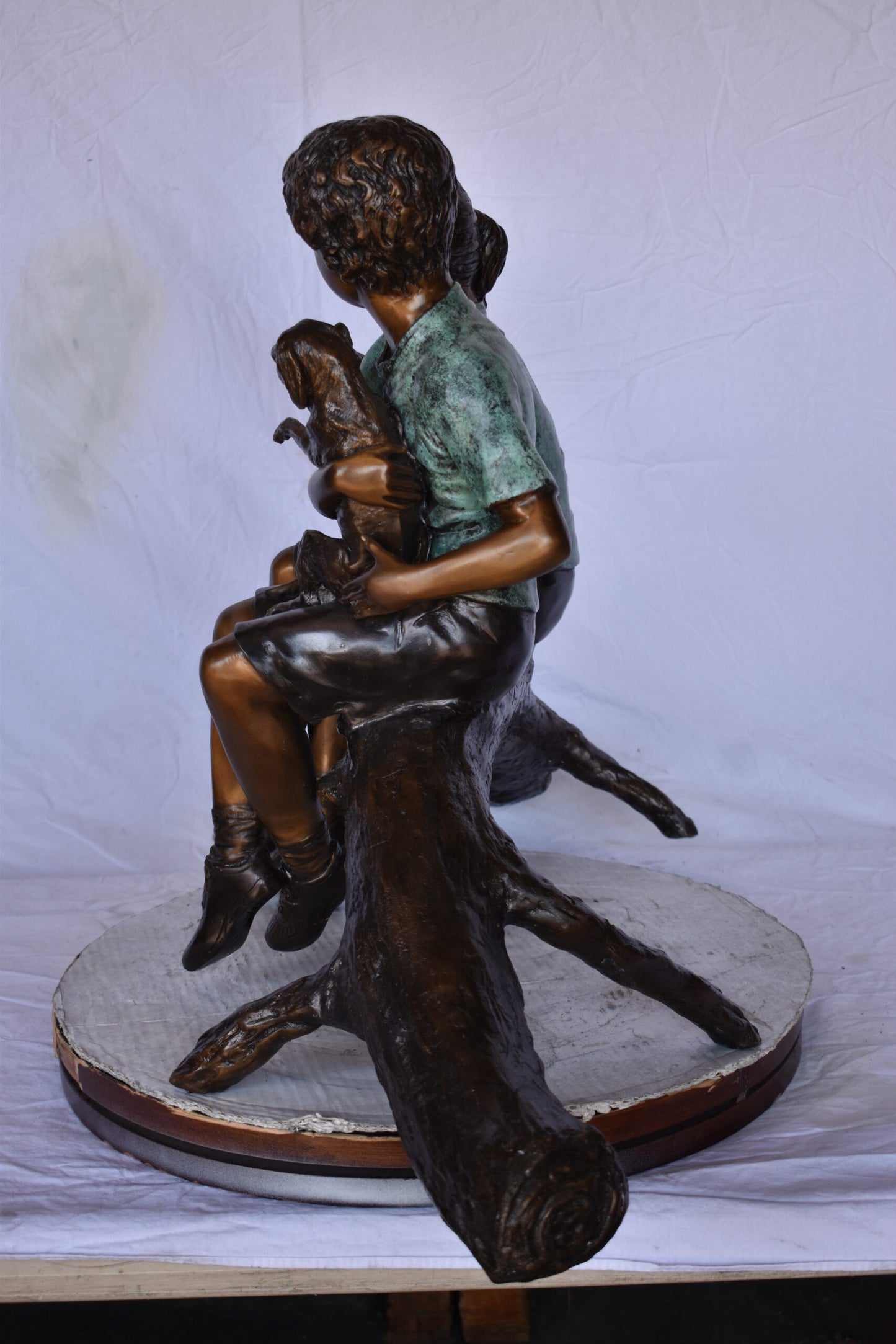 Boy and Girl with Pets Sitting on Log Bronze Statue - Size: 44"L x 22"W x 26"H.