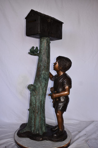 A Boy Standing by His Mailbox Looking at Birds Bronze Statue  25" x 22" x 51"H.