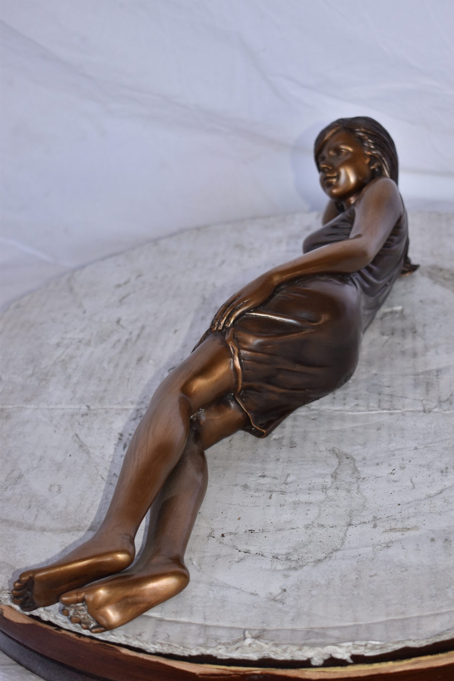 Gorgeous Young Lady Laying on The Ground Bronze Statue - Size: 5"L x 21"W x 5"H.