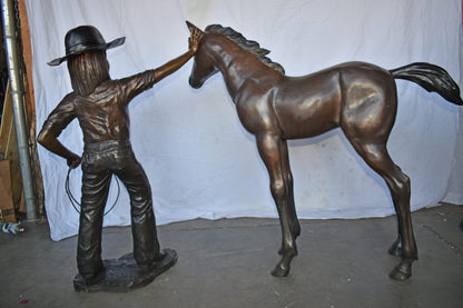 A Young Cowgirl with A Young Horse Bronze Statue Size: 60" x 30" x 44"H